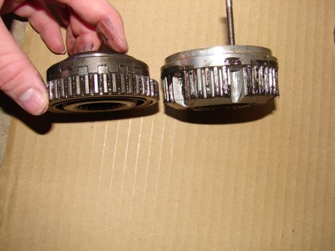 1996 Ford Bronco - Close-up of two metal hubs with gear-like teeth, one appearing damaged.