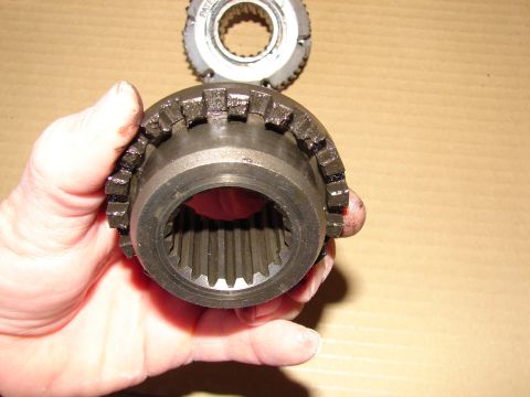 1996 Ford Bronco - Close-up of a metal gear part held in a hand, with another gear in the background.