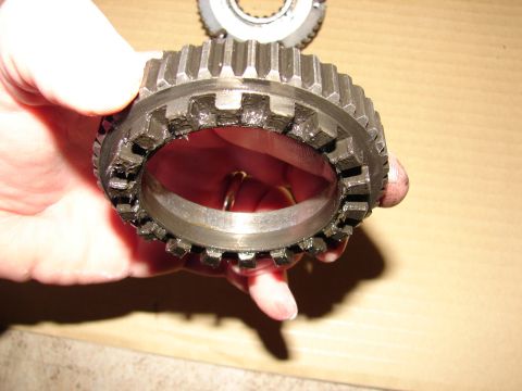 1996 Ford Bronco - A close-up view of a damaged gear hub being held by a person's hand.