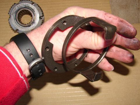 1996 Ford Bronco - Metal parts, possibly from a vehicle hub, held in a hand.