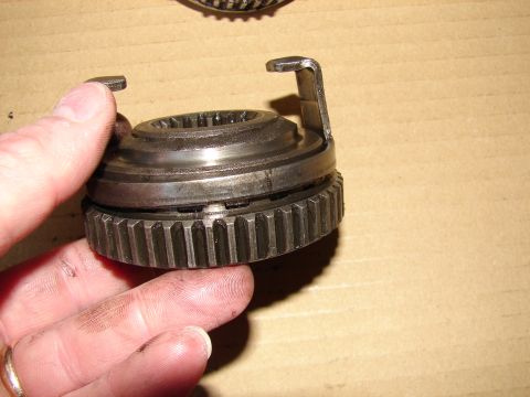 1996 Ford Bronco - A close-up view of a metal gear part, likely from a vehicle's drivetrain, being held by a hand.