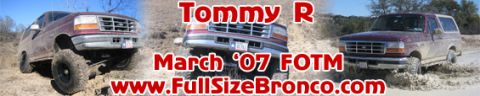 1996 Ford Bronco - Maroon Ford Bronco with lifted suspension driving through mud.