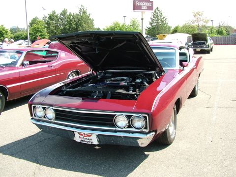 1972 Ford Ranchero - Red 1970 Ford Torino GT with hood open, parked next to another car. A Residence Inn sign is visible.