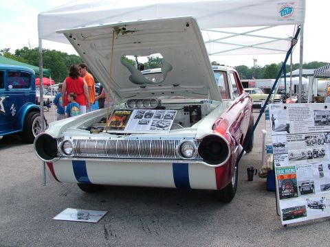 1972 Ford Ranchero - A customized drag car is displayed with its hood open, revealing the engine and informational boards.
