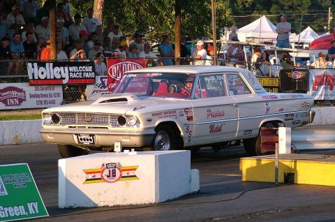 1972 Ford Ranchero - A cream-colored 1963 Ford Falcon drag car with racing decals sits on the track, ready for competition.