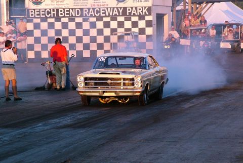 1972 Ford Ranchero - A car performs a burnout at Beech Bend Raceway Park, creating a cloud of smoke.