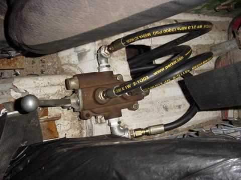 1992 Ford Bronco - Close-up of a hydraulic valve assembly with hoses, likely part of a vehicle's winch system.