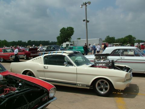 1972 Ford Ranchero - A white 1965 Ford Mustang GT350 with a prominent supercharger and roof rack is displayed at an outdoor event.