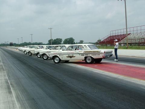 1972 Ford Ranchero - A line of white 1964 Ford Thunderbolt drag cars are parked on the drag strip, ready for a race.
