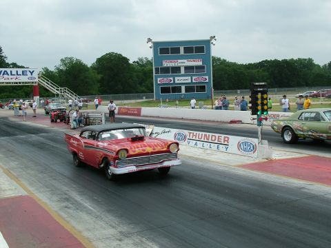 1972 Ford Ranchero - A red 1957 Chevrolet Bel Air drag car with flame decals races down the track at Thunder Valley.