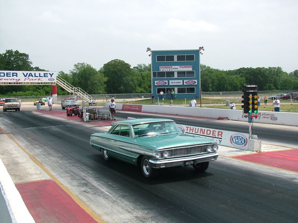 Teal 1964 Ford Galaxie 500 two-door sedan on a drag strip, front view