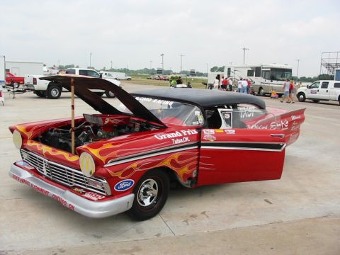 1972 Ford Ranchero - Customized 1957 Ford Fairlane drag car with flame graphics and racing decals. Hood and door are open.