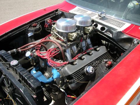 1972 Ford Ranchero - Close-up of a modified Ford V8 engine dual carburetors and prominent red spark plug wires.