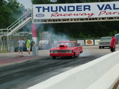 1972 Ford Ranchero - A red drag car burns rubber on the track at Thunder Valley Raceway Park.