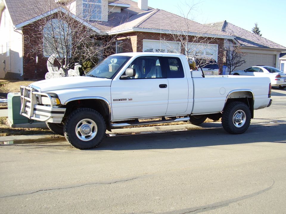 White 2001 Dodge 2500 pickup truck parked on street, front bull bar, crew cab