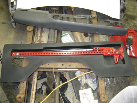 1990 Ford Bronco - Interior car parts are laid out on a workbench with a hi-lift jack.