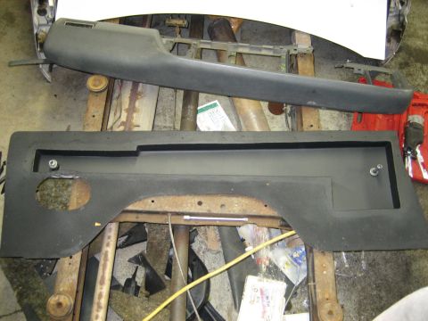 1990 Ford Bronco - Car interior parts are laid out on a wooden surface, possibly for repair or replacement.