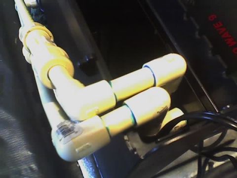 1993 Ford C-350 (Centurion Conversions) - Close-up of plumbing fittings, one with a visible barcode label.