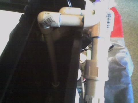1993 Ford C-350 (Centurion Conversions) - A section of plumbing with various PVC pipes and connectors is visible.