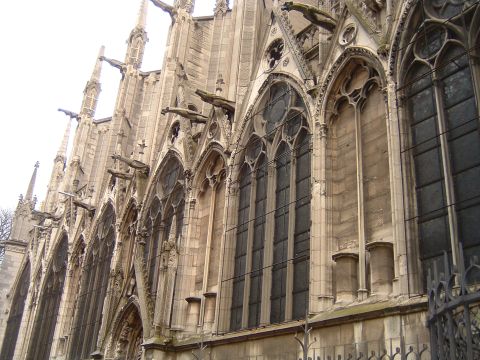1992 Ford Probe - The ornate facade of a Gothic cathedral features intricate stonework and gargoyles overlooking the street.