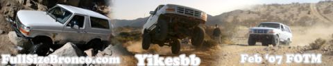 1996 Ford Bronco - Multiple Ford Broncos tackle challenging off-road terrain in a desert landscape.