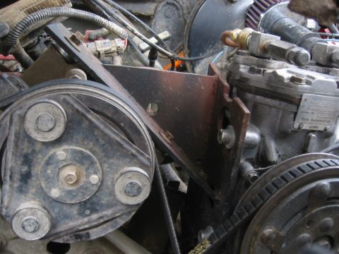 1995 Ford Bronco - Detail of engine parts, a pulley system and a York Automotive compressor, with visible hoses and wiring.