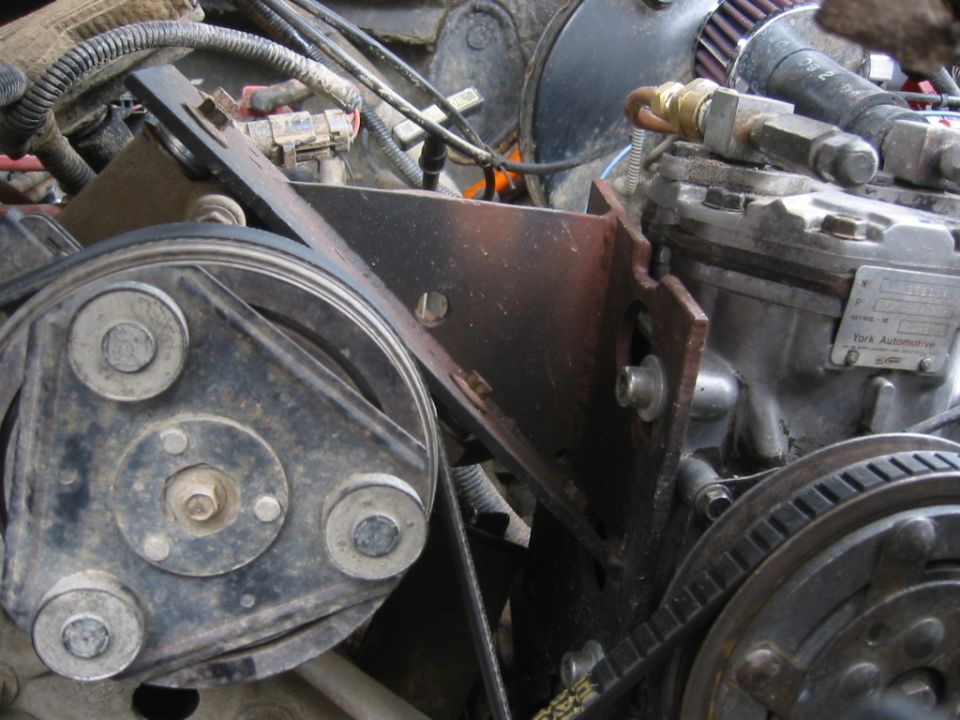 Close-up of engine components including a pulley system and a York Automotive compressor