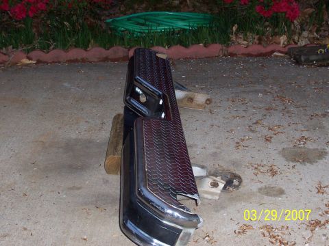 1988 Ford Bronco - A chrome and diamond plate rear bumper is shown, resting on wooden blocks.