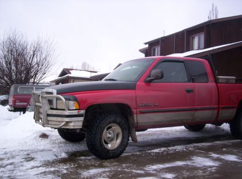 1989 Chevrolet Blazer - Red Dodge Ram 1500 V8 pickup truck with brush guard parked in the snow.