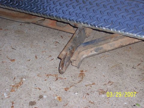 1988 Ford Bronco - Close-up of rusted metal frame and diamond plate, likely from a vehicle part.