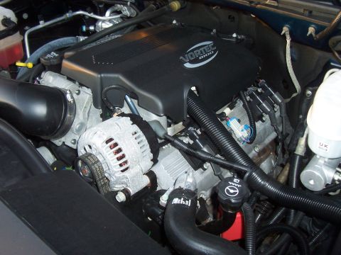 1994 Ford F-150 - Close-up view of a Vortec 8100 engine, showing the alternator, various hoses, and engine cover.