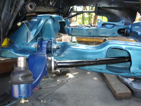 1992 Ford Taurus - The teal-painted frame and blue suspension components of a vehicle are shown in this close-up.