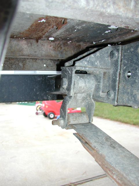 1984 Dodge 3500 - Leaf spring and frame detail, with toy vehicles in the background.