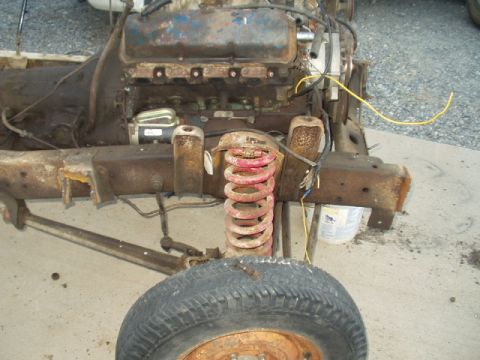 1993 Ford Bronco - Close-up of a heavily rusted vehicle frame, showing engine components and suspension.