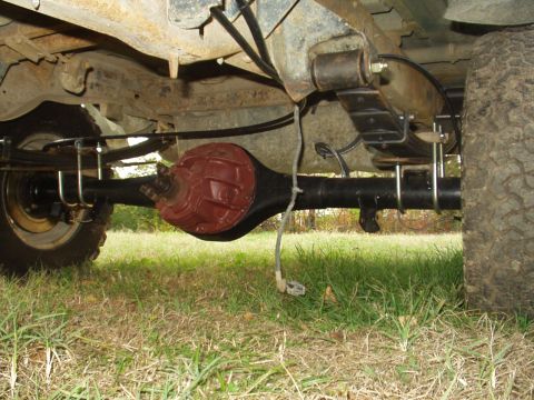 1993 Ford Bronco - The rear axle assembly and suspension components are visible from underneath the vehicle.