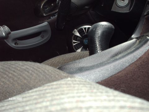 1995 Ford Probe - Interior view of a car, highlighting the door panel, gear shifter, and an aftermarket speaker.