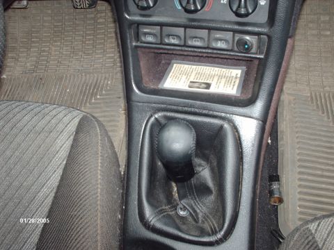 1995 Ford Probe - The photo shows the interior of a car, focusing on the center console and gear shifter.
