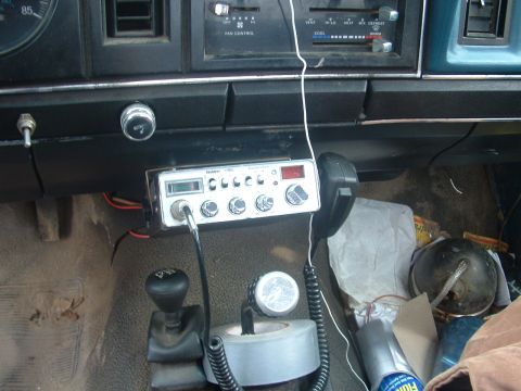 1983 Ford Ranger - The interior of a vehicle shows a CB radio mounted to the dashboard and a gear shifter.