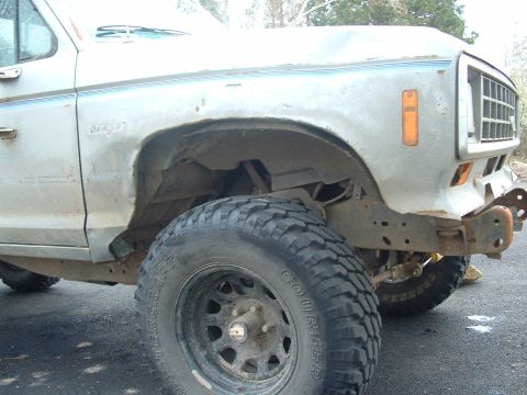 1983 Ford Ranger - Front quarter view of a 1983 Ford Ranger pickup truck, showing the fender, wheel, and off-road tire.