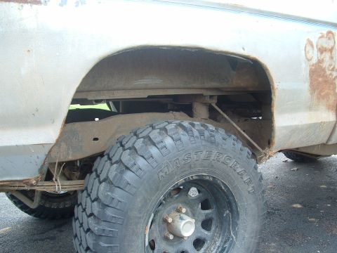 1983 Ford Ranger - Rear wheel well and suspension details of a pickup truck, showing the Mastercraft tire and rusty body panels.