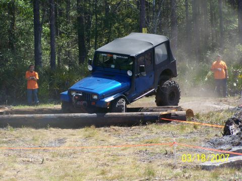 1989 Ford Bronco - Jeep Wrangler navigates an obstacle course with logs and dirt. Date stamp shows 03/18/2007.