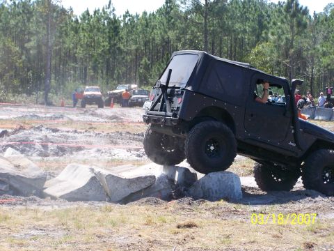 1989 Ford Bronco - A black Jeep Wrangler navigates a challenging obstacle course during an event in 2007.