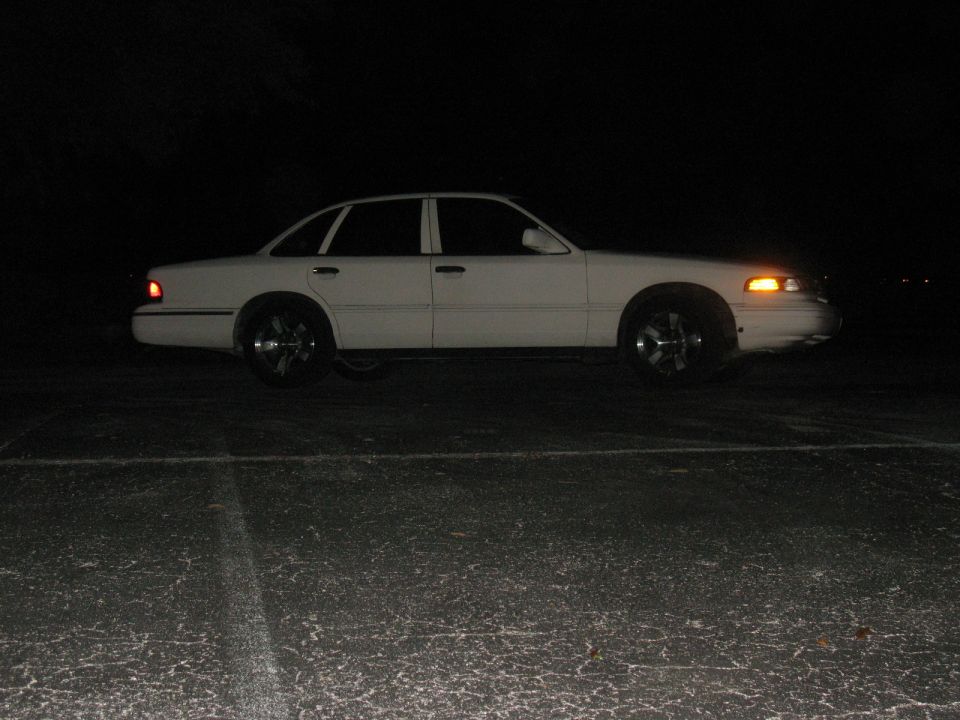 1997 Ford Crown Victoria parked at night, side view