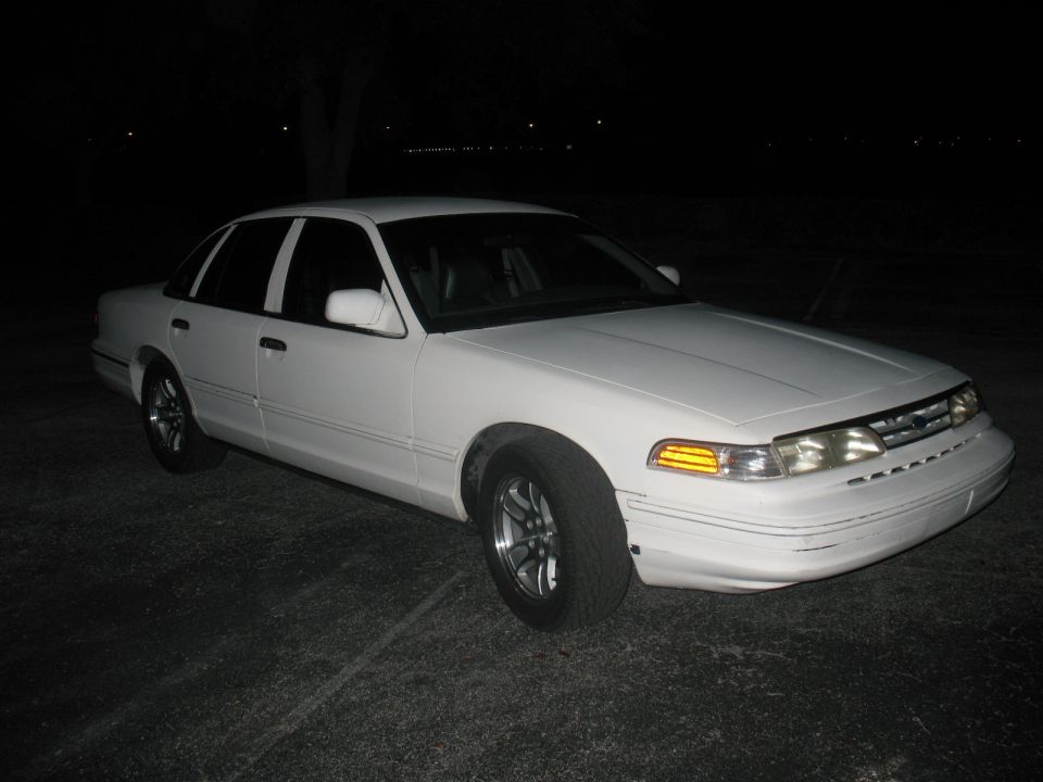 White 1997 Ford Crown Victoria parked at night