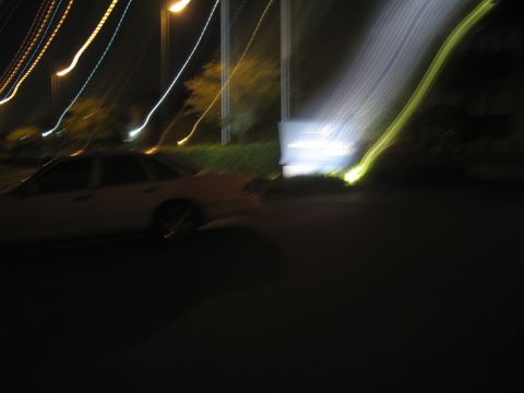 1997 Ford Crown Victoria - A 1997 Ford Crown Victoria is seen from the side at night, with motion blur from lights streaking across the frame.