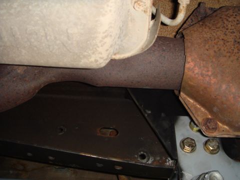 1996 Ford Bronco - Close-up view of the undercarriage, focusing on the exhaust system and frame components.