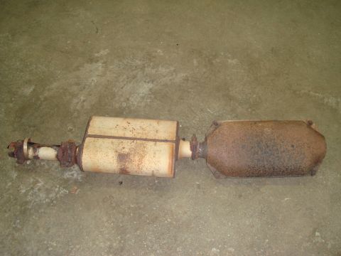 1996 Ford Bronco - A used exhaust system part, showing signs of rust and wear, is displayed on a concrete surface.