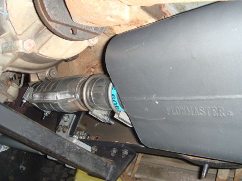 1996 Ford Bronco - Close-up view of a Flowmaster muffler and catalytic converter, part of a vehicle's exhaust system.
