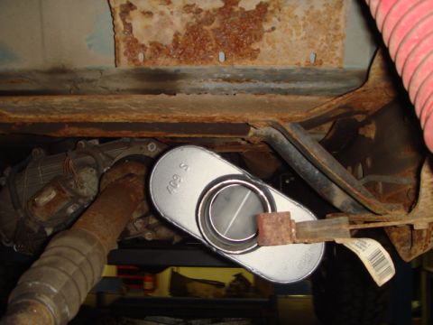 1996 Ford Bronco - Close-up of vehicle undercarriage showing exhaust muffler and transmission components.