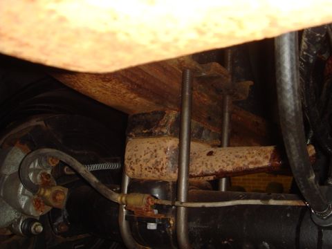 1996 Ford Bronco - Close-up view of the rear axle and leaf spring assembly, showing U-bolts and brake line details.